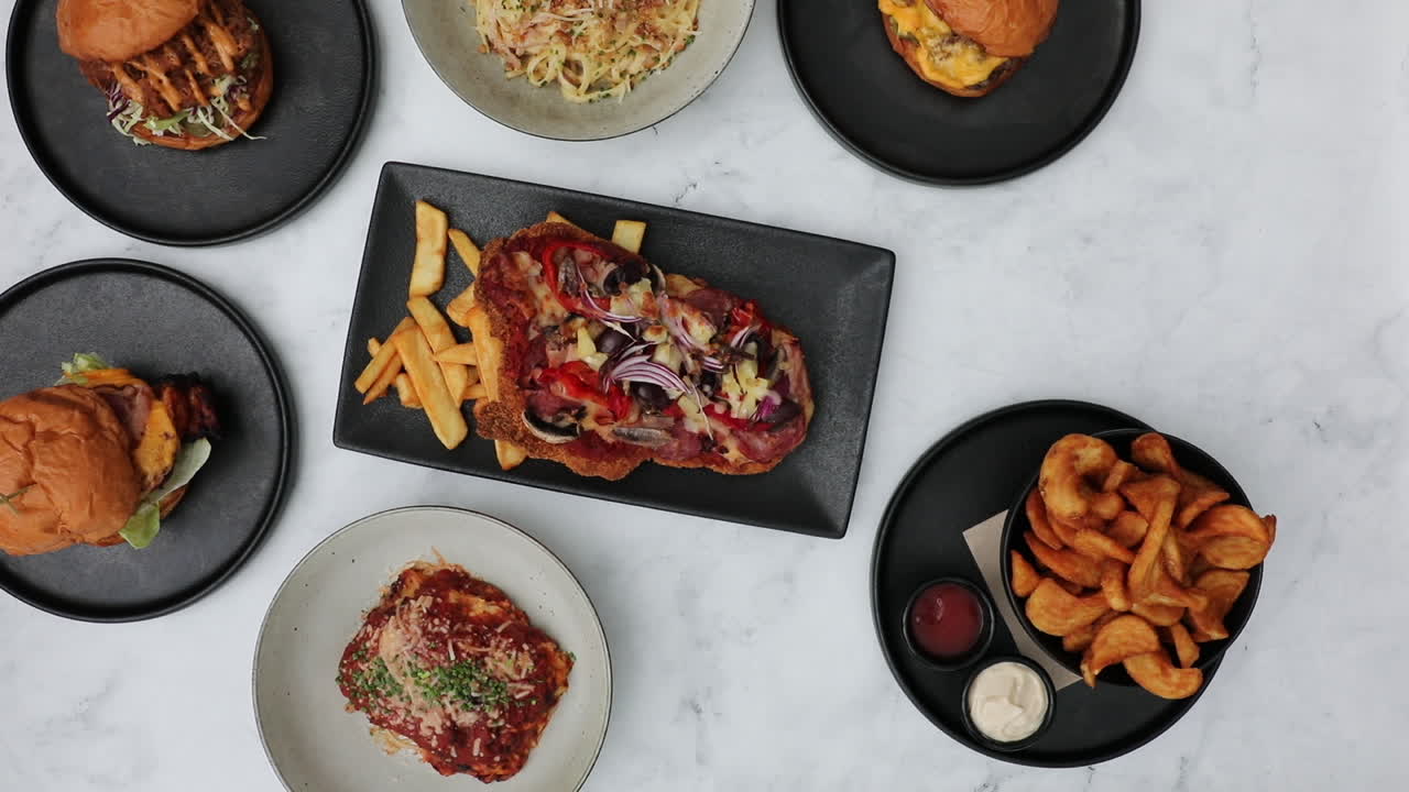 las manos de los camareros bajando la bebida de cola naranja y negra de la mesa del restaurante