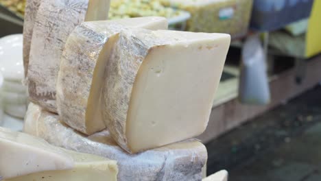 closeup of a block of white cheese for sale at a market