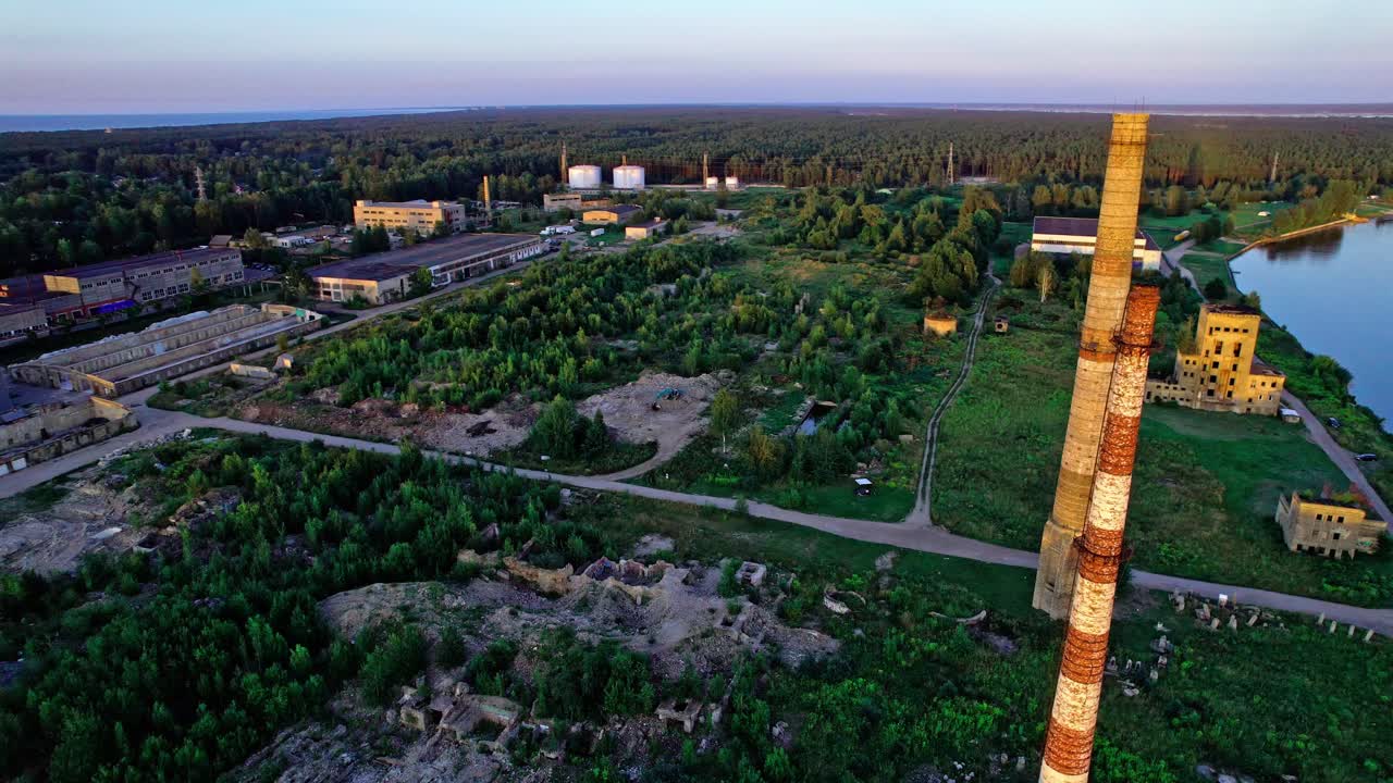 Industrial ruins beside river in Latvia during golden hour