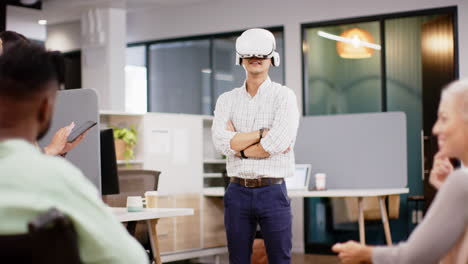 using vr headset, man standing with arms crossed in modern office meeting