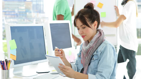 Cute-creative-designer-working-sitting-at-her-desk-