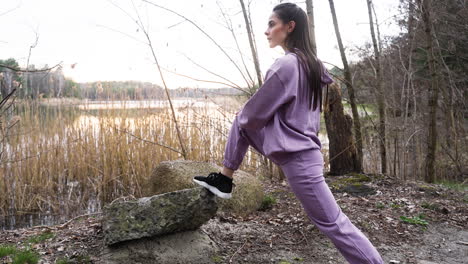 woman stretching in the forest