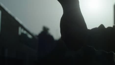 silhouette of hands in city