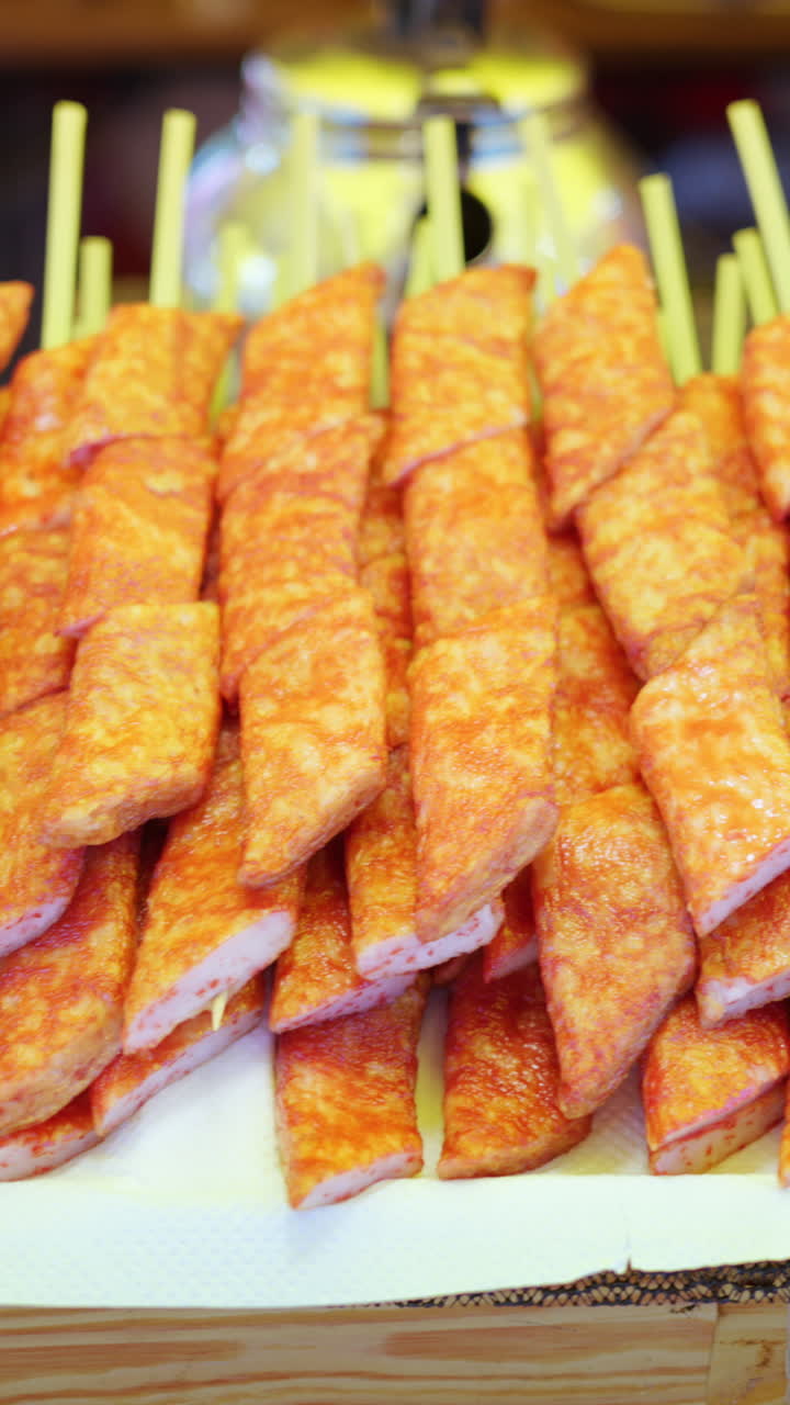 Close up of crab meat skewers at a street food market in Japan. Vertical