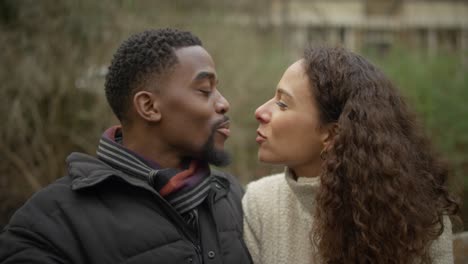 affectionate couple share a kiss