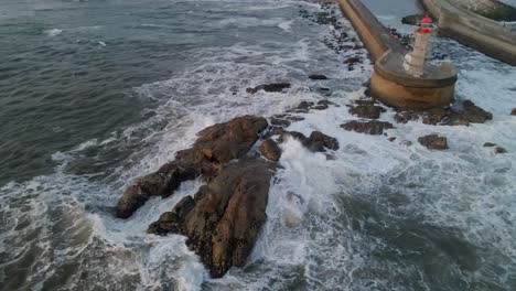 waves-crash-rocky-coastline,-Felgueiras-lighthouse,-Porto---drone