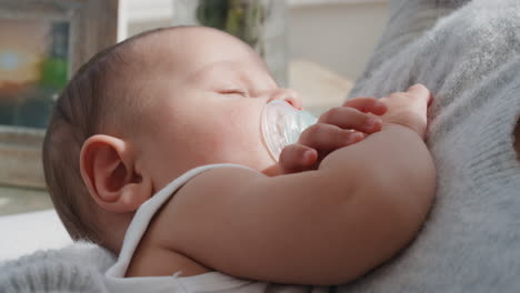 baby sleeping peacefully in mothers arms loving mother holding infant caring for sleepy toddler at home 4k