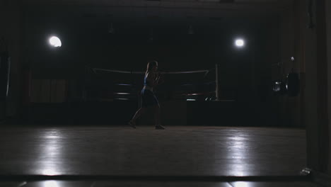 Athletic-woman-doing-fitness-exercises-to-box-and-practice-self-defensive-techniques.-steadicam-shot