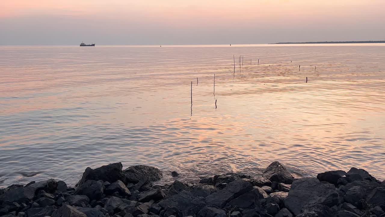 멀리 보트와 해가 지는 평온한 바다