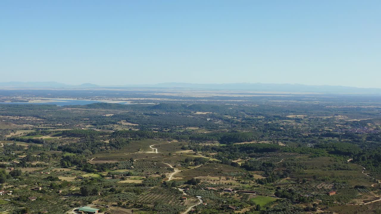 Aerial drone view of the Tiétar valley in the area where we visualize the Rosarito reservoir, in this part we appreciate the width of the valley, in the background you can see the mountains.