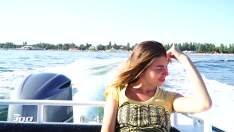 happy girl chilling on the moving boat in the sea