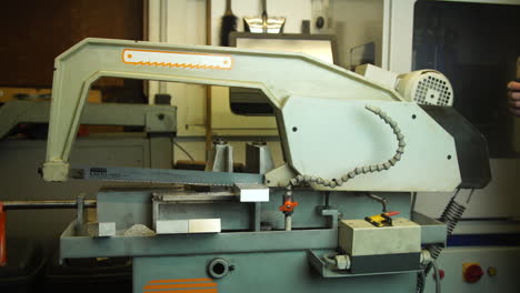 automatic metal saw cuts metal in handicraft workshop