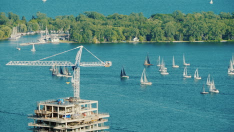 view of the construction of a skyscraper in the background there are many yachts in the bay toronto