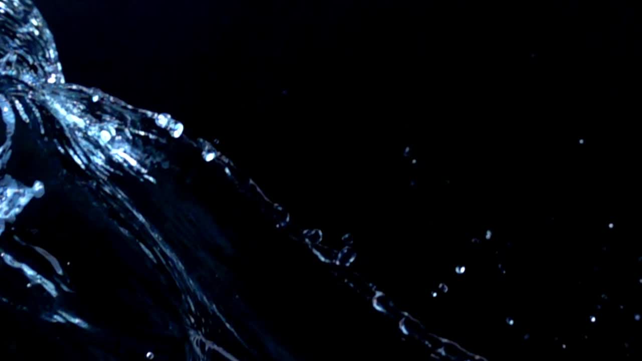 Water on a black background. Slow motion