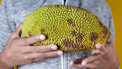 person holding a jackfruit