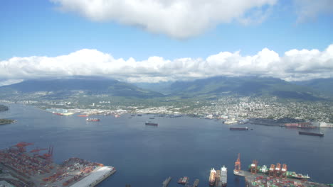 north vancouver and lonsdale ship yards from helicopter looking north towards the second narrows bridge, grouse mountain and seymour mountain in british columbia