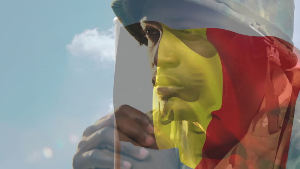 Man in camo jacket loosening grip at pole, raising head as flag overlay blending, honoring troops