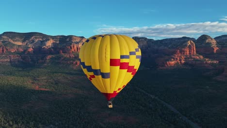 yellow hot air balloon in sedona, arizona - aerial drone shot