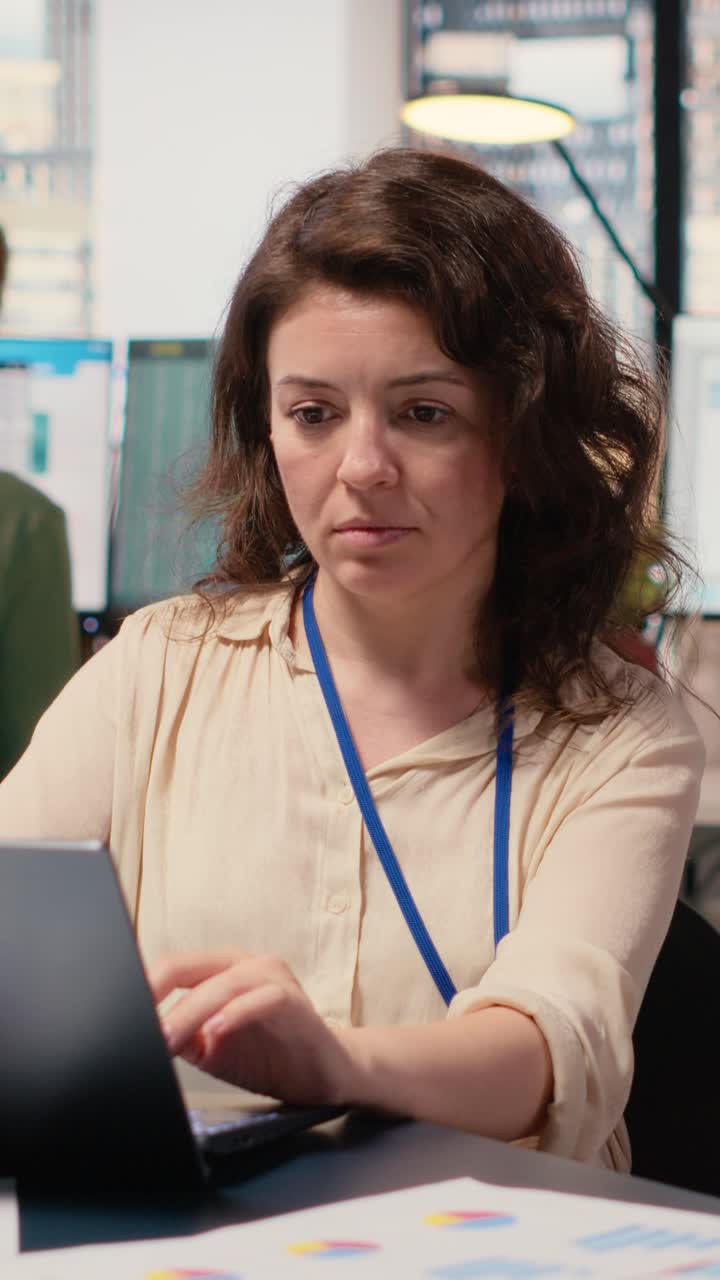 Vertical Video Female general director reviewing data insights on her laptop