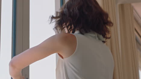 beautiful travel woman dancing in hotel room having fun celebrating summer vacation enjoying carefree holiday lifestyle