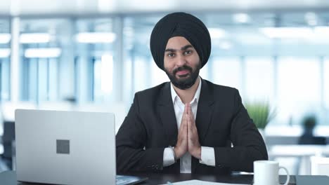 happy sikh indian businessman doing namaste