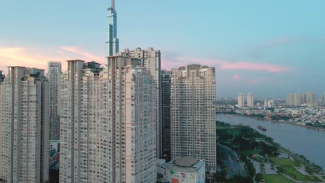 Drone-flying-above-tall-buildings-in-urban-centre-of-Ho-Chi-Minh-City,-Vietnam