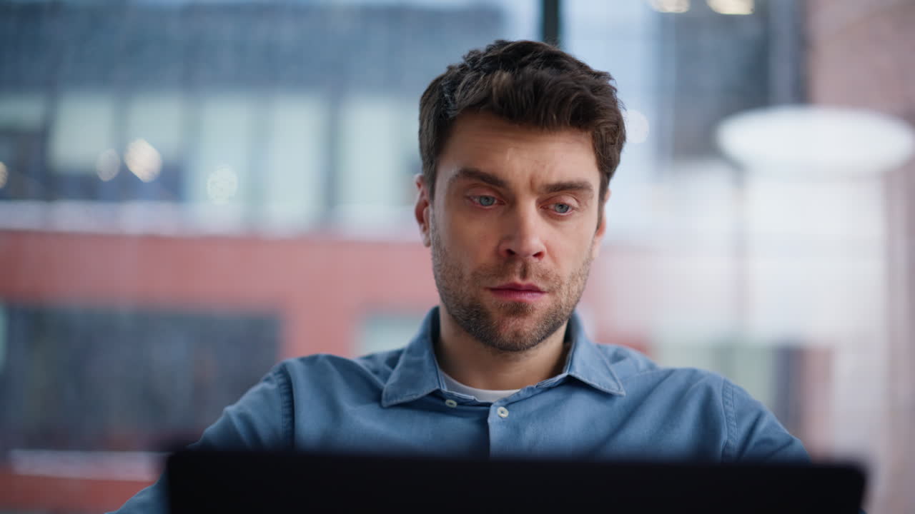 Focused programmer thinking code looking laptop closeup. Serious man developer