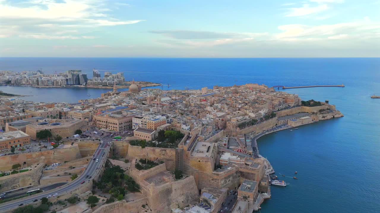 Aerial views of Valletta reveal its iconic limestone buildings, narrow streets, and breathtaking harbor.