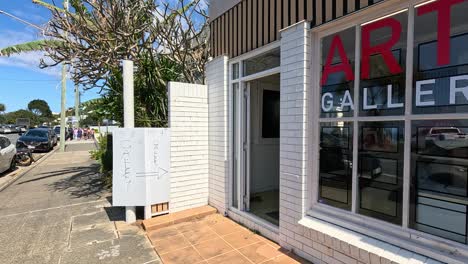 art gallery exterior with parked cars nearby