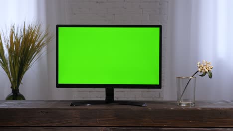 smart tv monitor green screen. contemporary living room tv green chroma key screen television set 2000s. lcd tv home watching television. flat screen television in bedroom interior