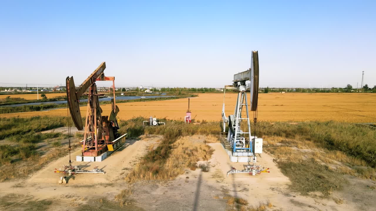 Industrial petroleum fossil fuel extraction equipment, crude oil drilling rigs, pumpjacks machinery pumping derrick in oilfield ground conveying industry power energy global energy consumption
