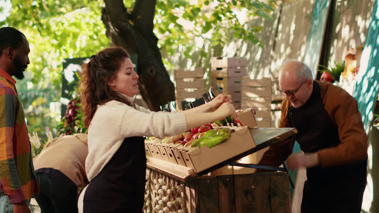 People selling fresh produce at a farmers market