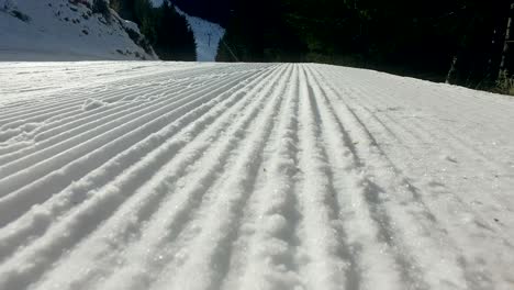 snow lines made from a snow machine on a ski slope, cinematic steadicam shot