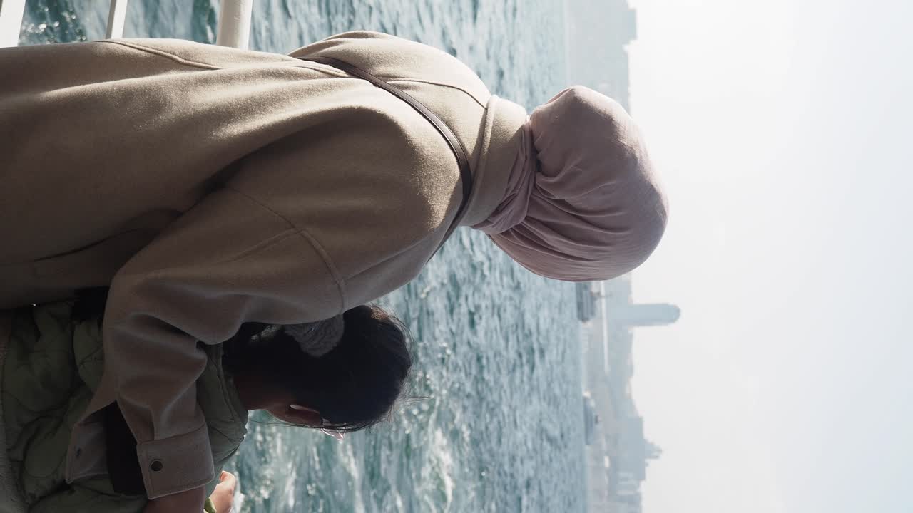 People on a ferry looking at the cityscape