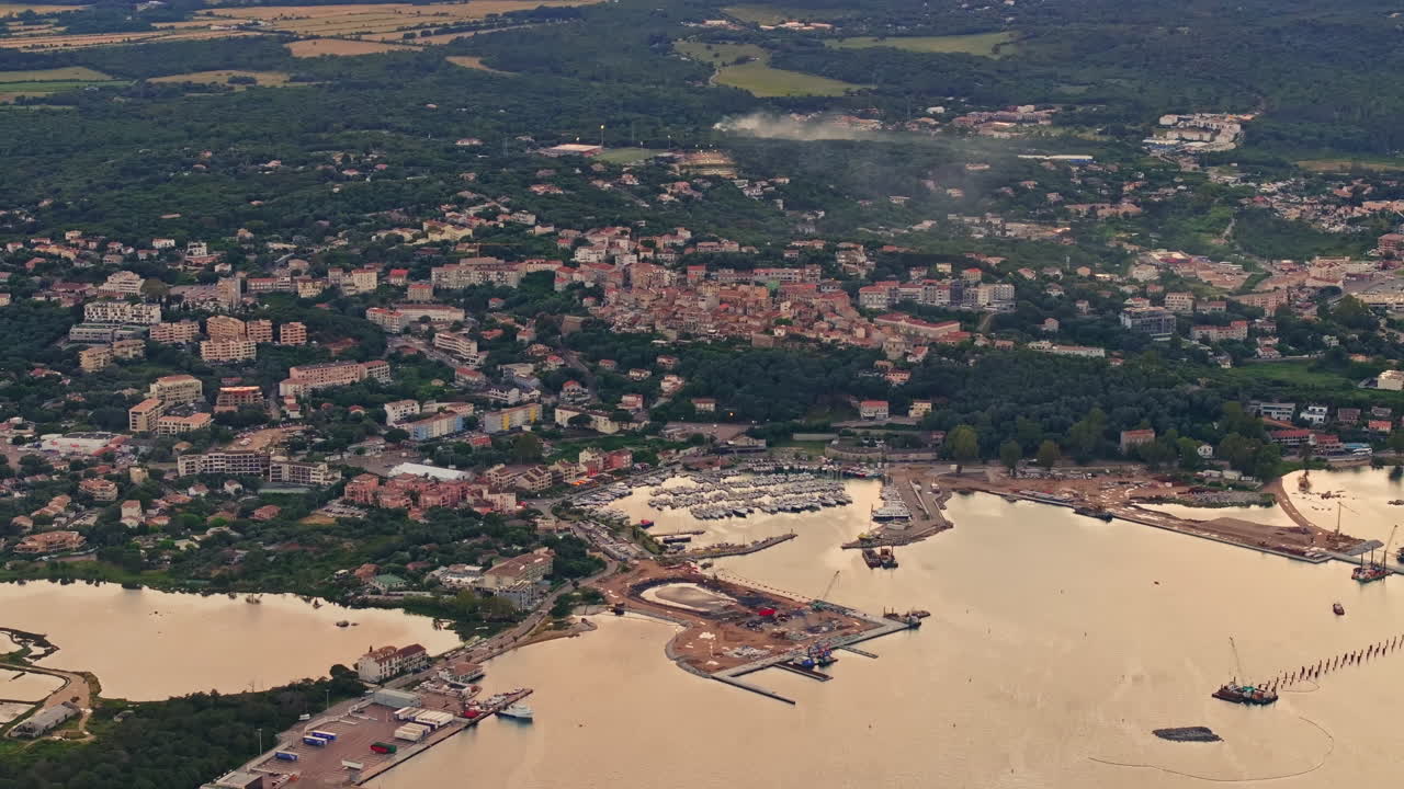 Aerial drone shot over the coastline of Porto Vecchio, southern Corsica, France. Golden hour sunset, warm colorful sky