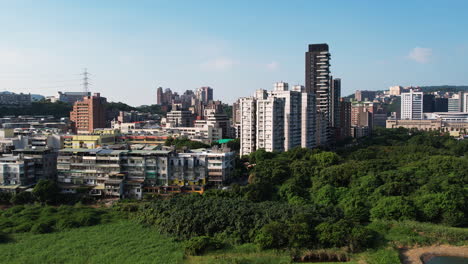 wetlands border apartment building homes in guandu, beitou district, taipei, taiwan