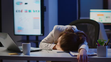 Freelancer-working-overtime-falling-asleep-with-hand-on-financial-documents