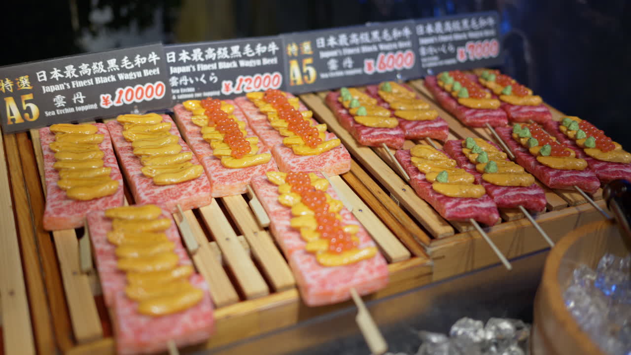 Close up of Wagyu beef with different toppings on skewers at the Tsukiji Fish Market in Chuo, Tokyo, Japan