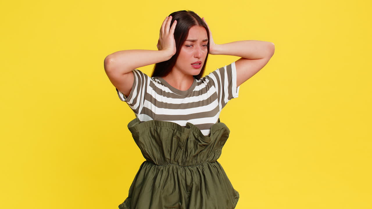 Woman covers ears with hands grimacing refusing to hear bad news avoiding unpleasant negative sound