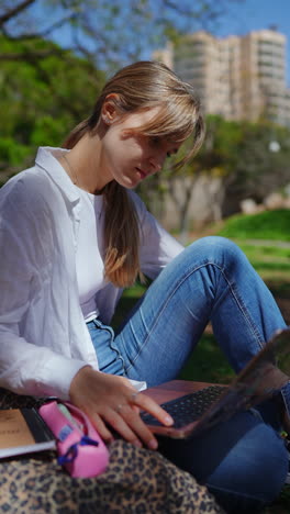 woman studying outdoors with laptop