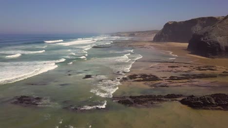 aerial shot over the big waves at the coastline of portugal