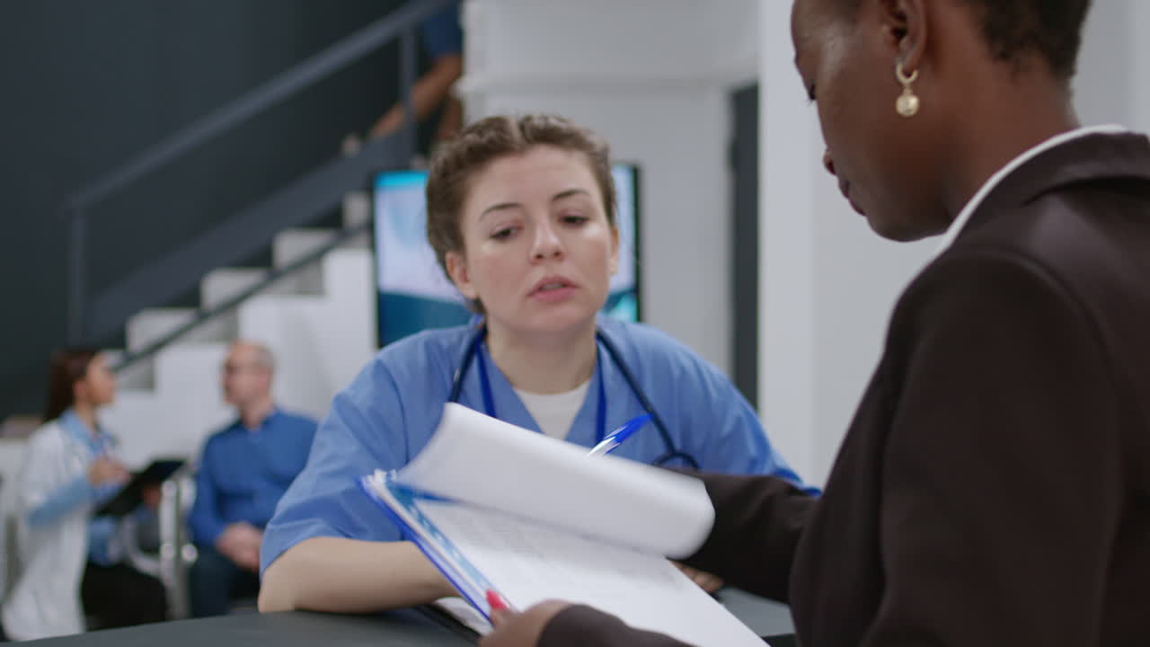 Medical Staff Assisting Patient at Hospital Reception