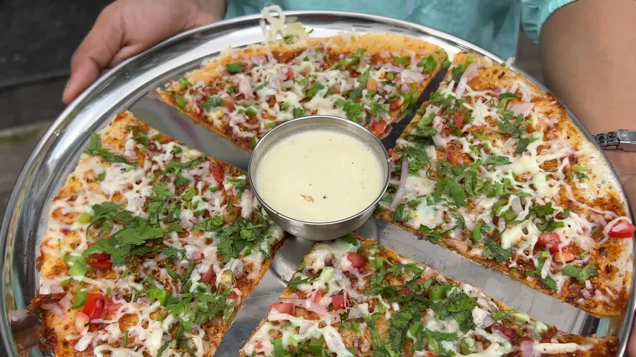 Pizza dosa, a fusion dish prepared in a south Indian restaurant in Kolkata