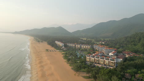 high angle drone of chan may bay and beach with luxury vietnam hotel in lang co