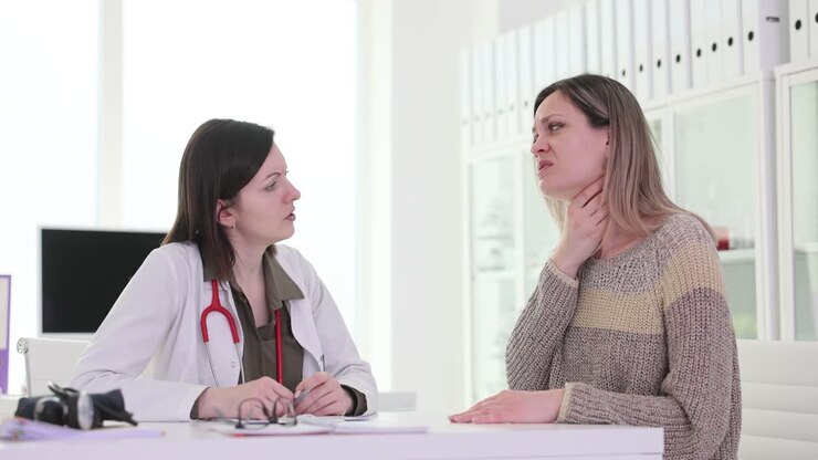 Patient with sore throat symptoms consults a doctor in a medical office