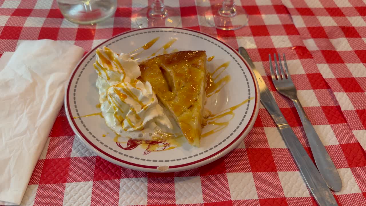 Zoom in on restaurant table with checkered tablecloth and pie on plate for dessert