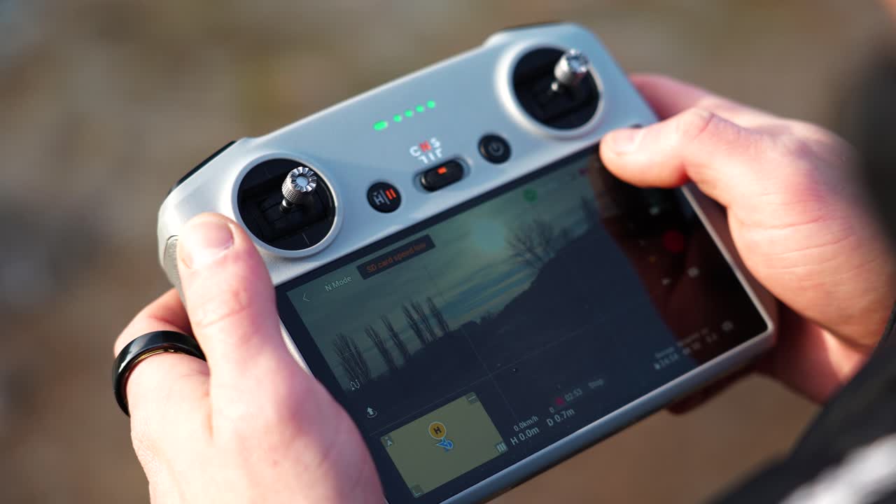 Close up of person hold drone remote control and open aircraft settings
