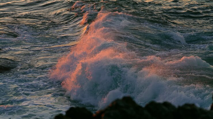 Powerful ocean waves foaming at sunrise nature close up. Sea streams splashing
