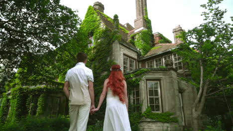 honeymoon couple looking at beautiful country house. fairytale house