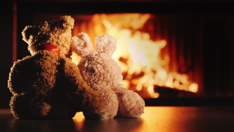 two friends a rabbit and a bear bask near the fireplace hugging - friendship and comfort in the hous